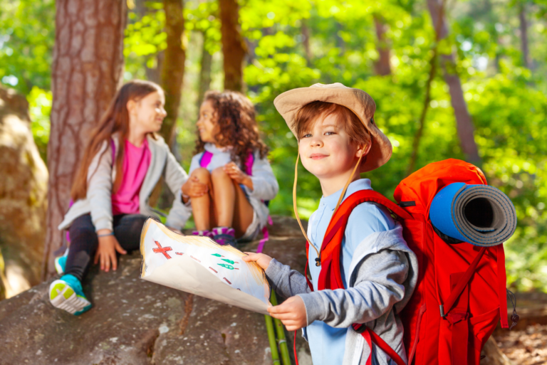 Children exploring outdoors with a treasure map — outdoor education activity